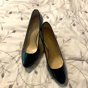 Black COACH patent leather pumps